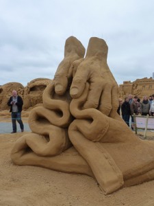 sand sculpture of hand by Daniel Doyle