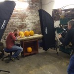 Professional pumpkin carver Jamie Wardley in the Sand In Your Eye workshop, posing with his pumpkins