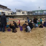 Loads of people getting stuck in at the sand sculpture workshop
