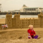 Florence looking pleased with herself with the Windsor Castle sand sculpture to celebrate the Queen's 90th Birthday